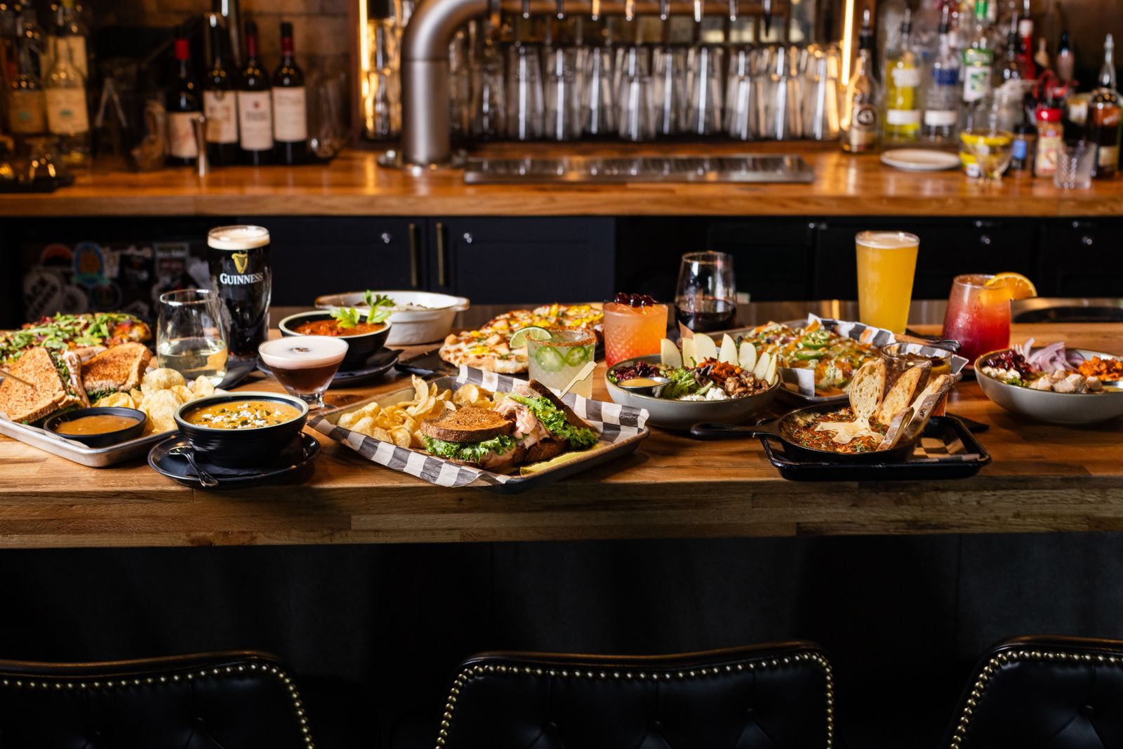 A spread of sandwiches, salads, and comfort dishes across the bar at Lucy's